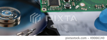 Electronic board with microchips on a hard drive background Electronic board with microchips on a hard drive background 49066140