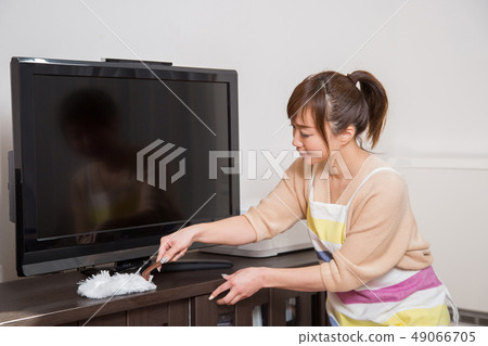 Woman cleaning the tv Woman cleaning the tv 49066705