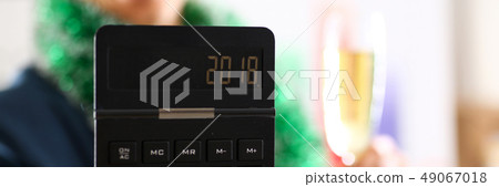 Man in suit hold in arm calculator with 2018 year Man in suit hold in arm calculator with 2018 year 49067018