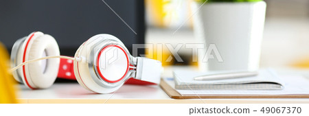 Empty remote office workplace with laptop and headset Empty remote office workplace with laptop and headset 49067370