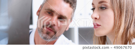 Mature male doctor hold in arm and look at xray photography 49067670