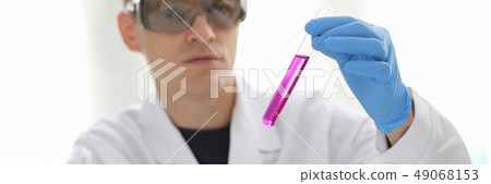 A male chemist holds test tube of glass A male chemist holds test tube of glass 49068153
