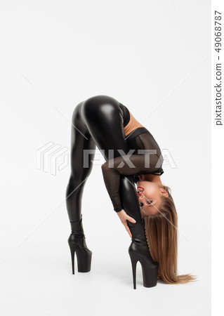 Erotic woman in leather pants and heels Erotic woman in leather pants and heels 49068787