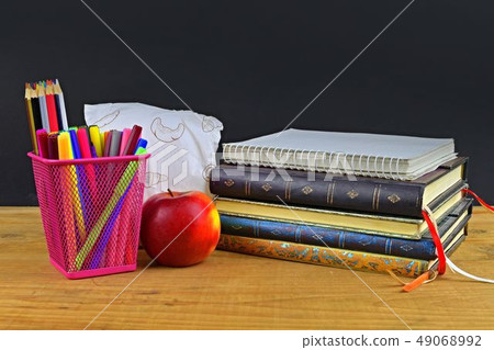 Concept of school lunch break with apple and school supplies on wooden desk, selective focus. Books Concept of school lunch break with apple and school supplies on wooden desk, selective focus. Books 49068992