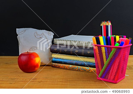 Concept of school lunch break with apple and school supplies on wooden desk, selective focus. Books Concept of school lunch break with apple and school supplies on wooden desk, selective focus. Books 49068993
