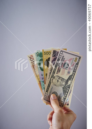 拿著日元和海外鈔票的女性手 拿著日元和海外鈔票的女性手 49069757
