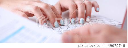 Female hands typing on silver keyboard using computer pc Female hands typing on silver keyboard using computer pc 49070746