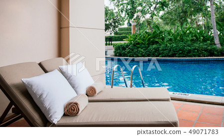 Resort pool beds at outdoor balcony by swimming Resort pool beds at outdoor balcony by swimming 49071783