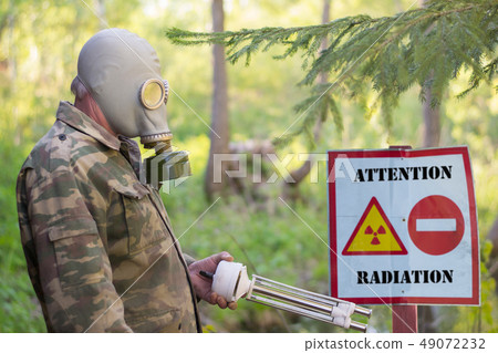 man in military uniform and in a gas mask  49072232