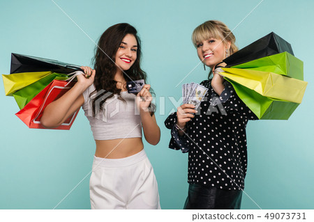 Two happy smiling girls with a credit card  49073731
