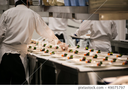 Material image of a chef working in a French kitchen Material image of a chef working in a French kitchen 49075797