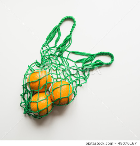 Shopping bag with orange. Zero waste concept. Shopping bag with orange. Zero waste concept. 49076167