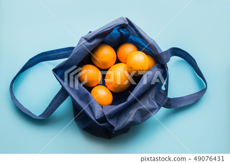 Zero waste. Blue shopping textile bag with orange  49076431