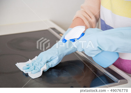 Woman Cleaning IH Cooking Heater Woman Cleaning IH Cooking Heater 49076778