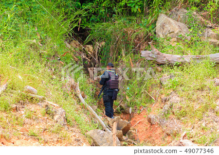 Soldier standing patrol walkway in mountain Soldier standing patrol walkway in mountain 49077346