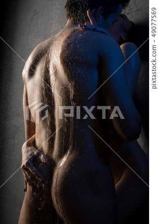 Attractive nude couple in steamy embrace view 49077569