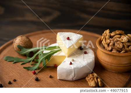Cheese camembert or brie with walnuts and arugula 49077915