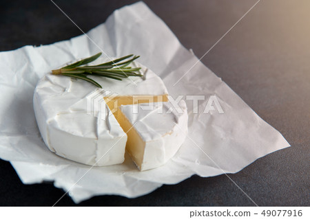 Cheese camembert or brie with fresh rosemary 49077916