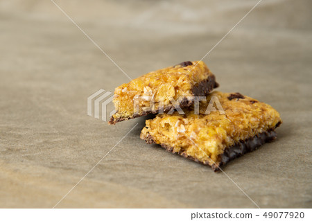 Muesli and cereal bar on marble stone background 49077920
