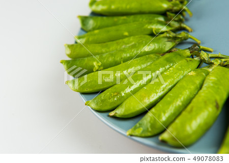 Fresh Green peas closeup on white background Fresh Green peas closeup on white background 49078083