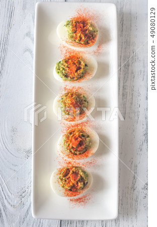 Guacamole and bacon deviled eggs Guacamole and bacon deviled eggs 49080129