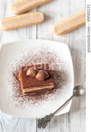 Portion of tiramisu on the white plate 49080131