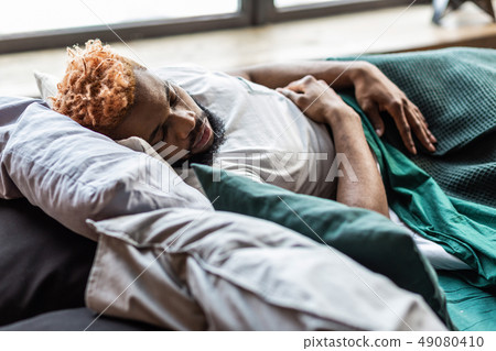 Good looking bearded man resting in the bed 49080410