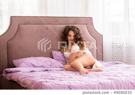 charming pregnant girl on the bed 49080810