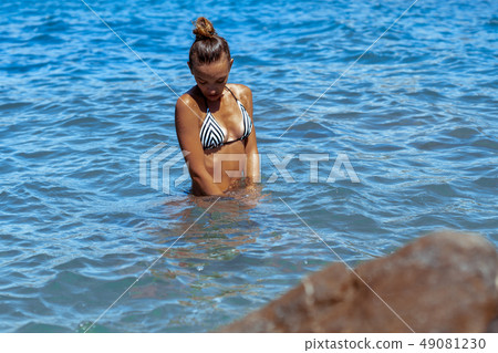 Sexy young lady in the ocean posing 49081230