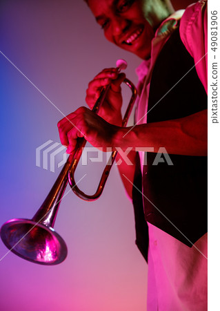 African American jazz musician playing trumpet. African American jazz musician playing trumpet. 49081906