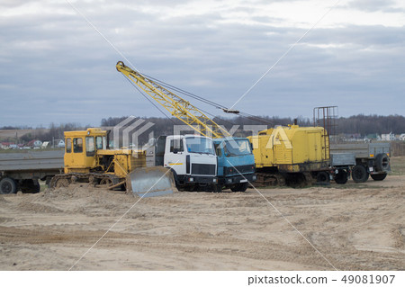 Excavator and trucks working on the excavation 49081907