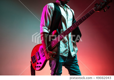 African American jazz musician holding bass guitar. 49082043