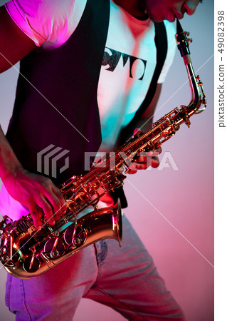 African American jazz musician playing the saxophone. 49082398