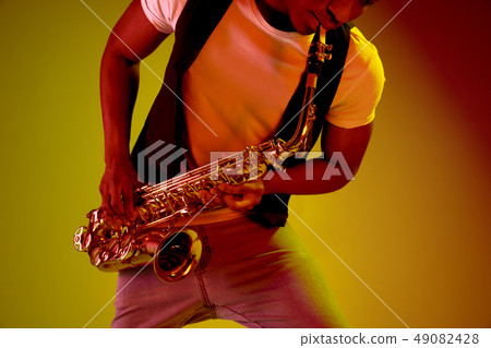 African American jazz musician playing the saxophone. African American jazz musician playing the saxophone. 49082428
