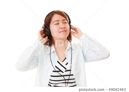 聽到音樂的一名微笑的婦女 聽到音樂的一名微笑的婦女 49082463