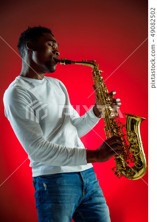 African American jazz musician playing the saxophone. African American jazz musician playing the saxophone. 49082502