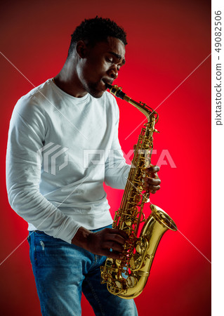 African American jazz musician playing the saxophone. 49082506