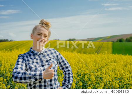 Farmer in rape field Farmer in rape field 49084180