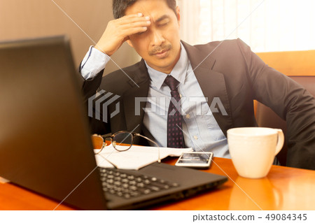 Businessman leaning with hand on his head on eyes closed feeling sleepy. 49084345