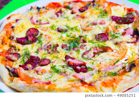 hot tasty fresh pizza on a plate close-up. green background 49085251