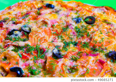 hot tasty fresh pizza on a plate close-up. green background hot tasty fresh pizza on a plate close-up. green background 49085271