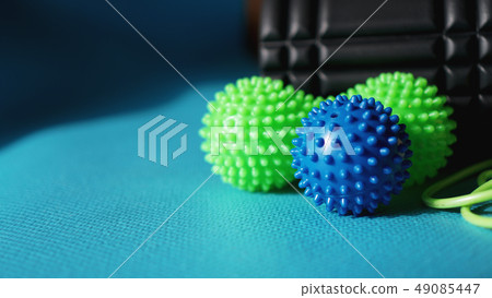 Massage ball roller for self massage, reflexology and myofascial release on blue Massage ball roller for self massage, reflexology and myofascial release on blue 49085447