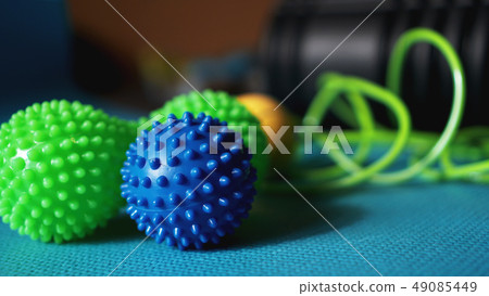 Massage ball roller for self massage, reflexology and myofascial release on blue Massage ball roller for self massage, reflexology and myofascial release on blue 49085449