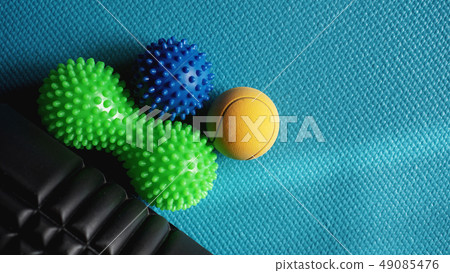 Massage ball roller for self massage, reflexology and myofascial release on blue Massage ball roller for self massage, reflexology and myofascial release on blue 49085476