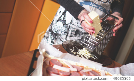 Closeup hand of chef baker making homemade pizza Closeup hand of chef baker making homemade pizza 49085505