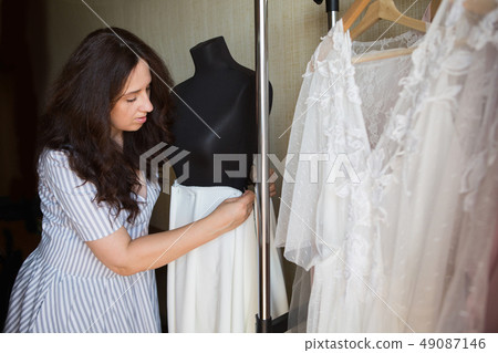 Dress designer making lace wedding dresses. Dress designer making lace wedding dresses. 49087146