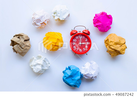 Red alarm clock ring with colorful crumpled paper Red alarm clock ring with colorful crumpled paper 49087242