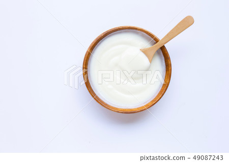 White yogurt in wooden bowl on white White yogurt in wooden bowl on white 49087243