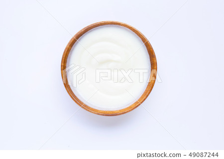 White yogurt in wooden bowl on white White yogurt in wooden bowl on white 49087244
