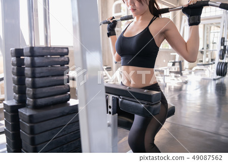 Exercise concept. A beautiful girl is exercising Exercise concept. A beautiful girl is exercising 49087562